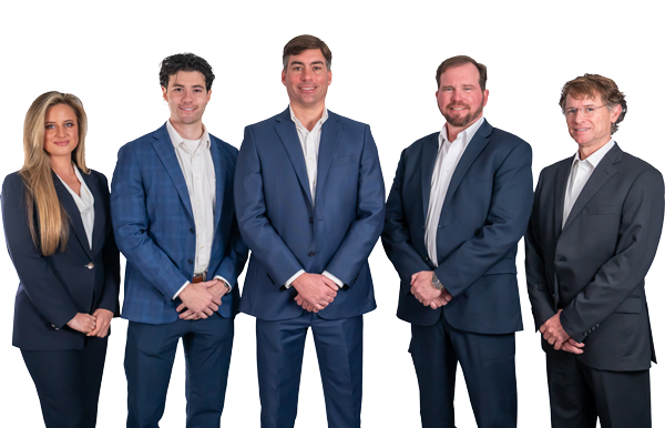 Five people wearing matching dark suits and white shirts stand in a row against a white background, facing forward and smiling at the camera.